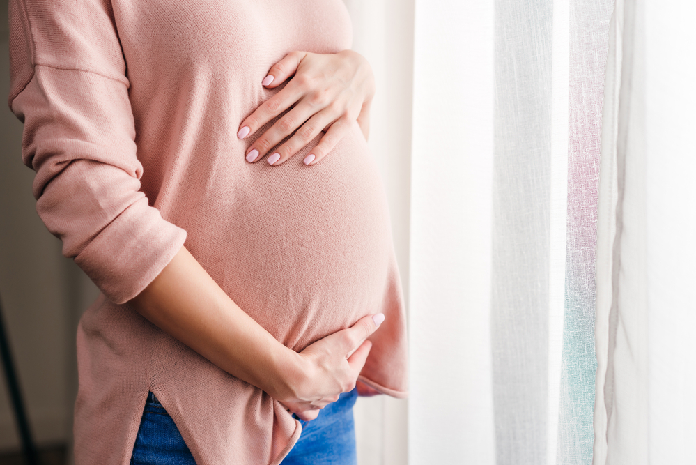 pregnant women holding tummy